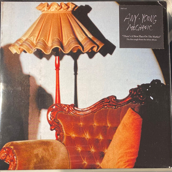Vinyl record cover featuring a floor lamp and a red velvet armchair.