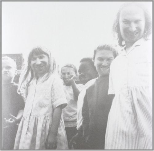 Black and white photo of children with the smiling face of Aphex Twin superimposed.