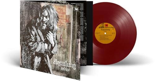 Vinyl record with a red disc and cover art featuring a bearded man.