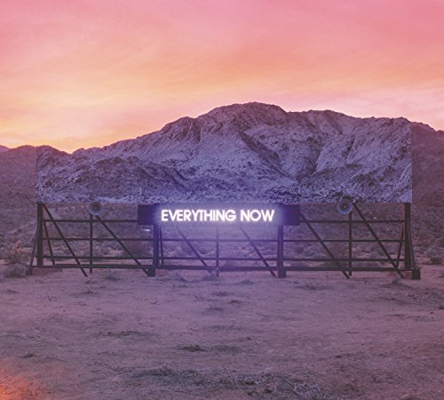 Neon sign reading EVERYTHING NOW on a desert billboard against a sunset mountain backdrop.