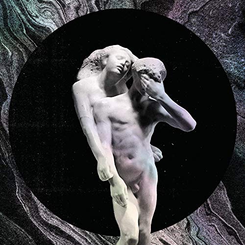 Two nude statues embracing in front of a black circle and marbled background.
