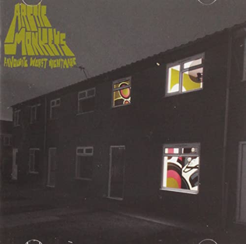 Arctic Monkeys album cover: dark brick building with colorful window shapes.