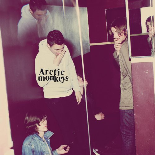 Arctic Monkeys band members in a dimly lit, slightly blurred portrait.