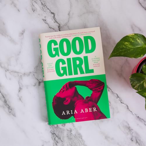 Book cover with green text and a silhouetted figure, next to a plant.