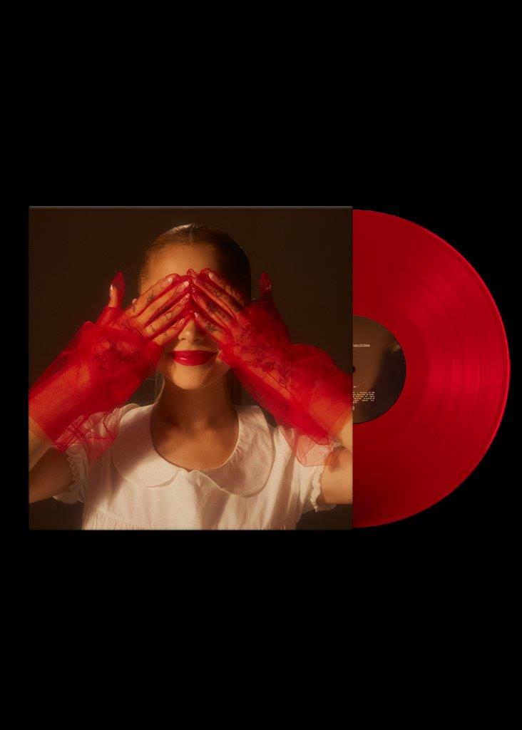 Red vinyl record with a portrait of Ariana Grande wearing red gloves.
