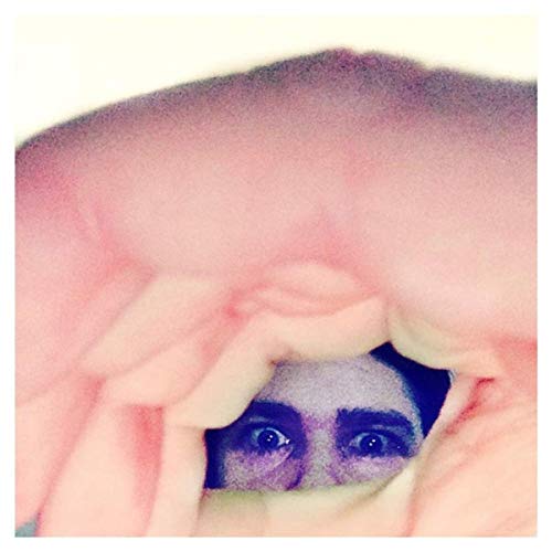 Close-up of a face with large eyes peering through distorted pink folds.