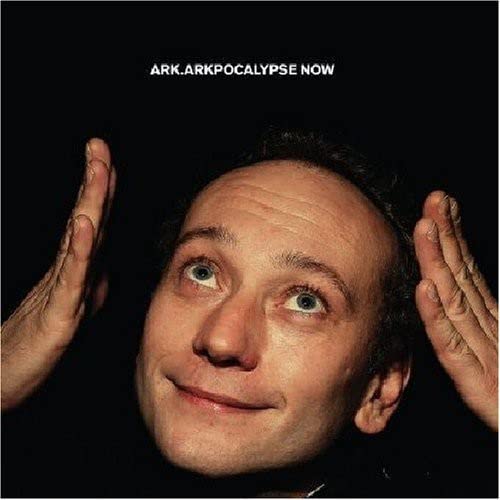 CD cover: Man looking up with hands framing his head.