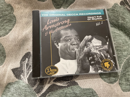 Louis Armstrong CD cover with black and white portrait playing trumpet.