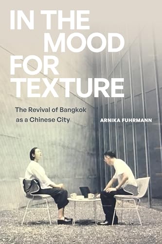 Book cover with two people seated outdoors, Bangkok city background.