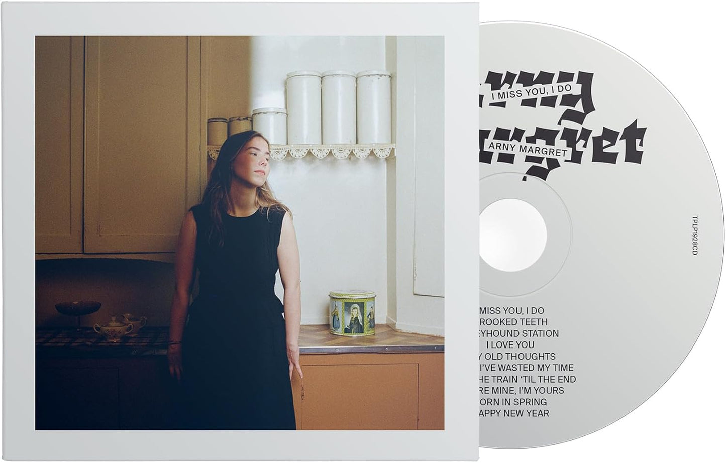CD case featuring a woman in a kitchen, tracklist on the side.