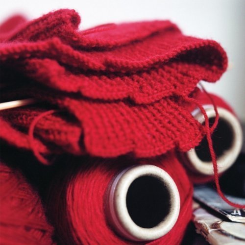 Red yarn and spools, close-up, representing the album "Try And Stay Upright.
