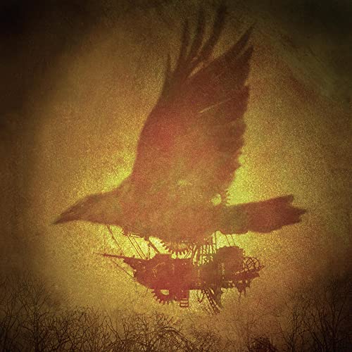 Dark image of a bird of prey flying over a silhouetted building.
