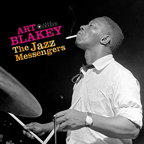 "Black and white image of Art Blakey playing drums with a cigarette."