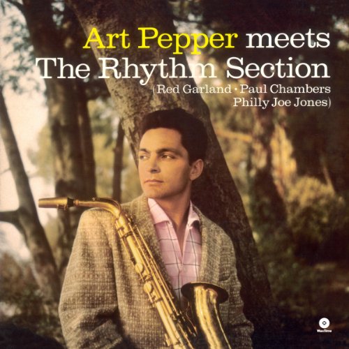 Art Pepper posing with a saxophone against a tree on a vinyl album cover.