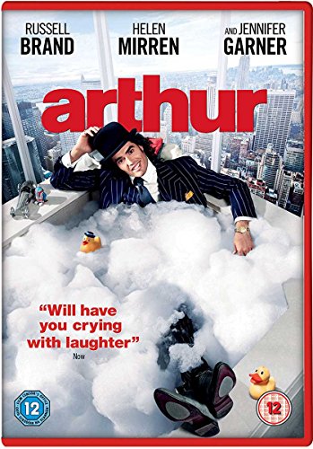Russell Brand in a suit and bowler hat sitting in a bubble-filled bathtub.