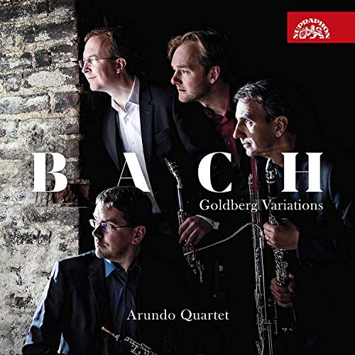 "CD cover featuring four men holding clarinets against a brick wall."