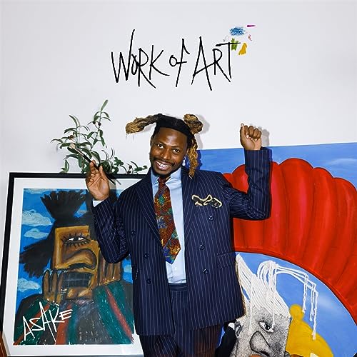 Asake in a pinstripe suit poses beside colorful artwork.