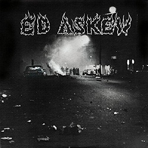 "Black and white album cover with a burning car and onlookers at night."