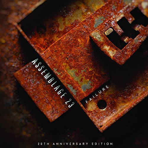 Rust-covered metal plates with "Assemblage 23 - Failure" text overlayed.