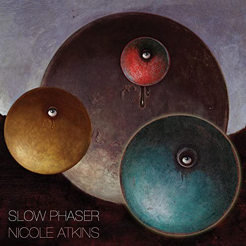 Album cover featuring three textured bowls with human eyes, text reading Slow Phaser Nicole Atkins.