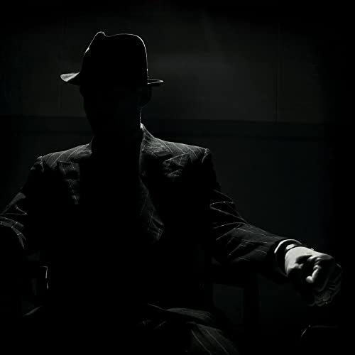 Silhouetted figure in a fedora and suit, dark and moody aesthetic.
