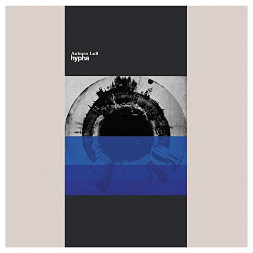 CD cover with an eye image and blue geometric shapes.