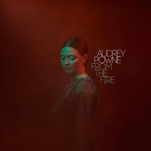 A woman in a glittery top against a deep red background with album text.