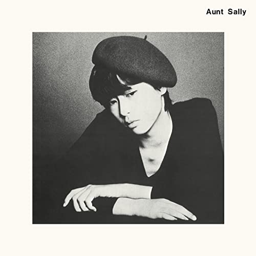 Black and white portrait of a person wearing a beret, looking down.