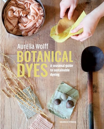 Hands dyeing fabric with botanical materials on a wooden table with a large spoon.