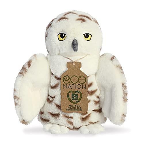White plush snowy owl with yellow eyes and a brown tag.