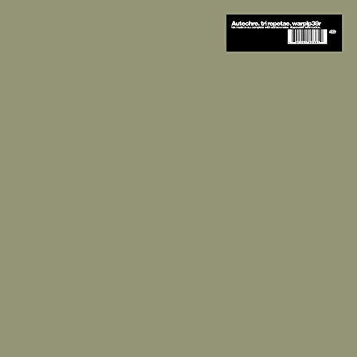 The image shows a vinyl record cover with a muted green background and a black rectangle. "Muted green vinyl record cover with black rectangle containing barcode at top right corner."