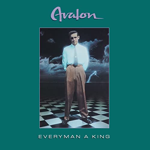 CD cover: Man in suit stands on checkered floor, stormy sky backdrop.