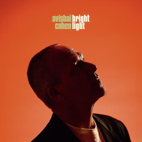 Avishai Cohen album cover: a man looking up, red and green tones.