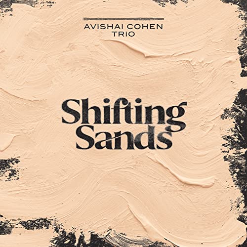 Album cover for Avishai Cohen Trio’s “Shifting Sands” with textured beige background.