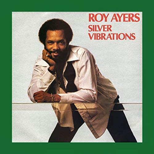 Album cover with a man leaning on a surface, wearing a white shirt and black tie.