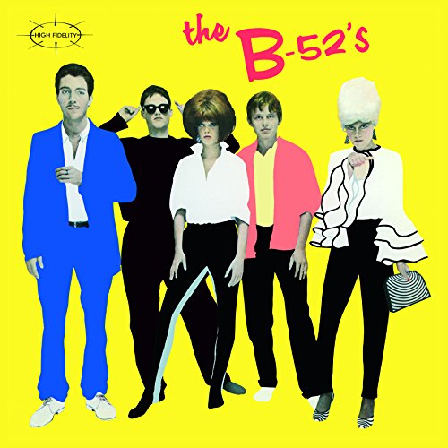 The B-52s band members pose against a bright yellow background on their album cover.