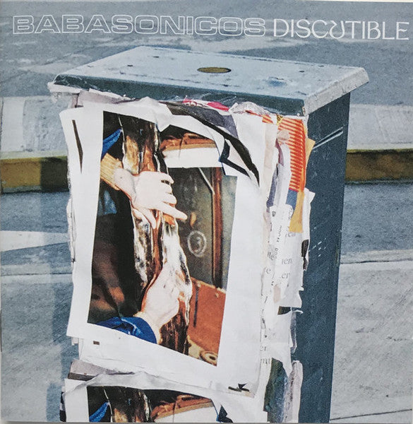 Babasonicos "Discutible" CD cover: a metal box covered in torn posters.