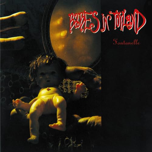 A doll sits in front of a circular mirror with text reading Babes in Toyland.