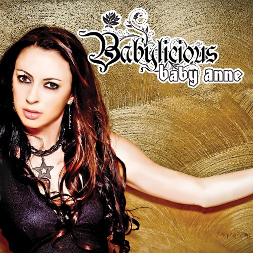 The image depicts a woman with long, dark hair and a black top, posing in front of a gold background. The text "Babylicious baby anne" is prominently displayed at the top right corner. Alt text: Woman with long dark hair and black top against gold background.