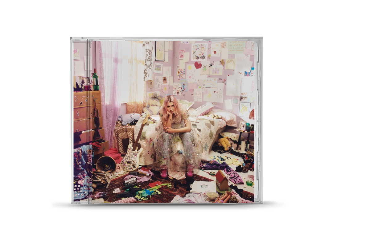 "CD case with a woman sitting in a messy bedroom."