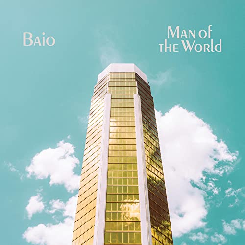 Alt text: "Tall golden building against a blue sky with clouds, titled 'Baio - Man of the World'."