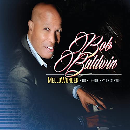 Bob Baldwin smiling while playing a piano on the Mellowonder album cover.