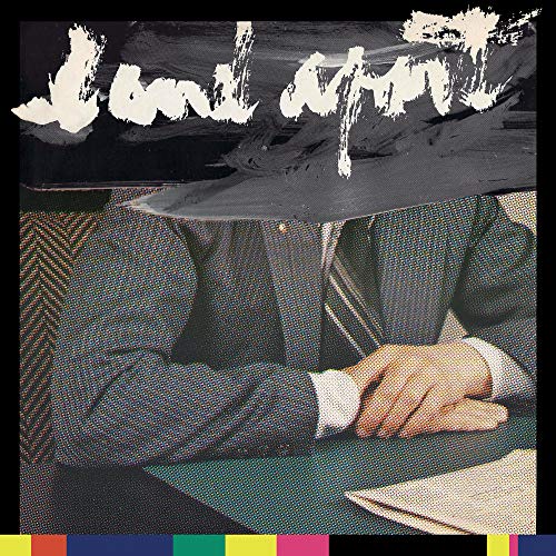 "Album cover featuring a man in a suit with a black paint smear over his face."