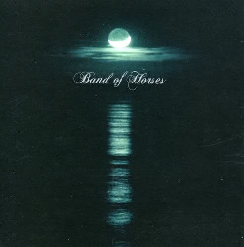 Dark album cover with a full moon reflected on water, band name above.