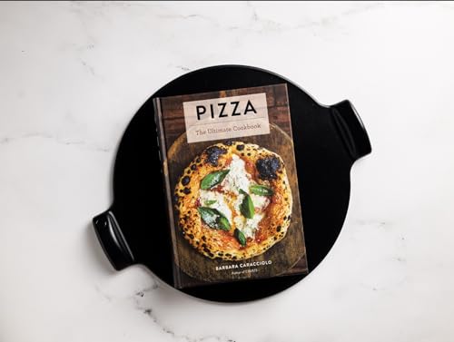 Pizza cookbook with a charred crust pizza on the cover, on a black tray.
