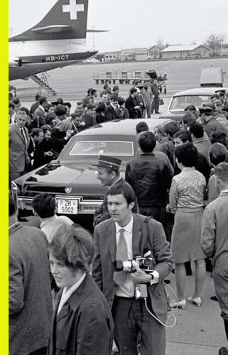 Black and white photo of a crowd around a car and airplane.