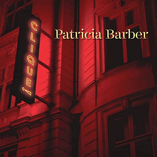Red building facade with a neon sign spelling “Clique!” and text “Patricia Barber”.