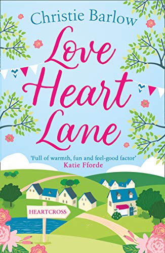 Book cover with pink title, village scene, and floral decorations.