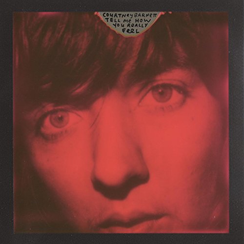 Red album cover featuring a close-up portrait of Barnett Courtney’s face.