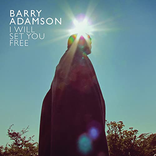 A hooded figure stands against a bright sun in a blue sky.